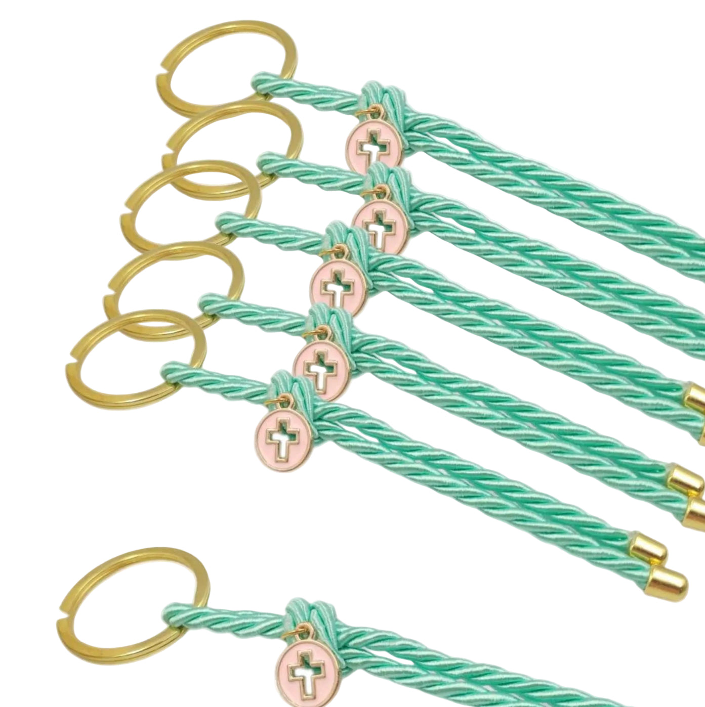 Set of green braided keychains with gold and pink charms on a white background
